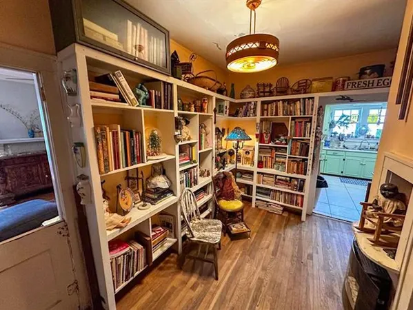 a living room with furniture a lamp and a fireplace