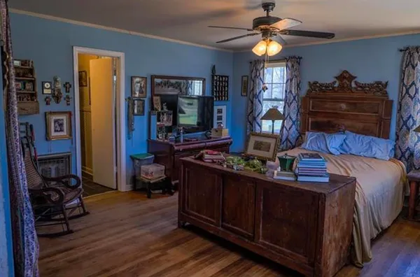 a bed sitting in a bedroom next to a window