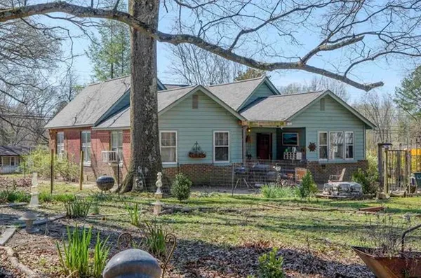 a front view of a house with garden