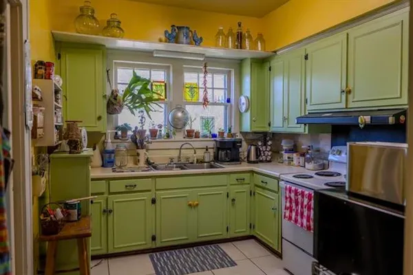 a kitchen with a sink cabinets and utility room