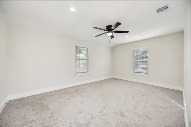 a view of room with hardwood floor and ceiling fan