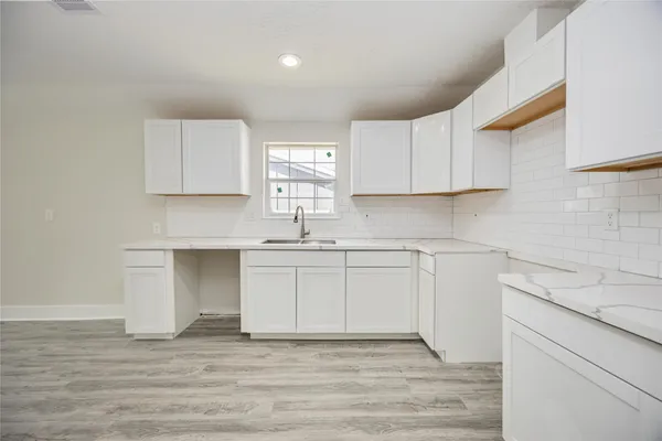 a kitchen with stainless steel appliances granite countertop a sink and cabinets