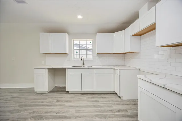a kitchen with stainless steel appliances granite countertop a sink and cabinets
