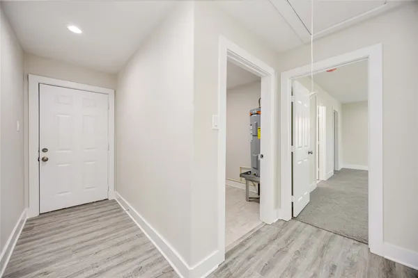 a view of a hallway with wooden floor