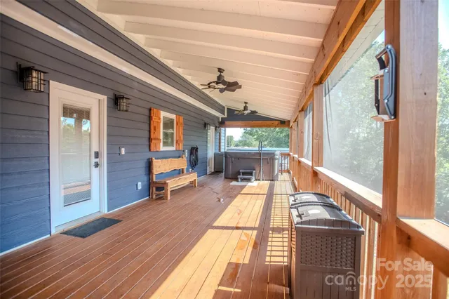a backyard of a house with plants and large tree