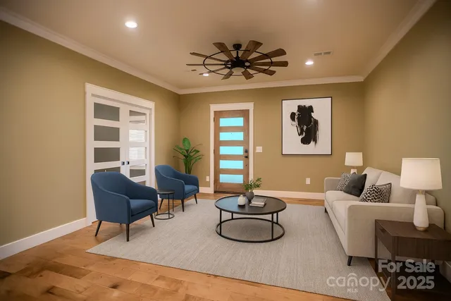a view of a livingroom with furniture window and wooden floor