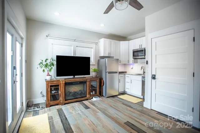 a living room with furniture flat screen tv and a fireplace