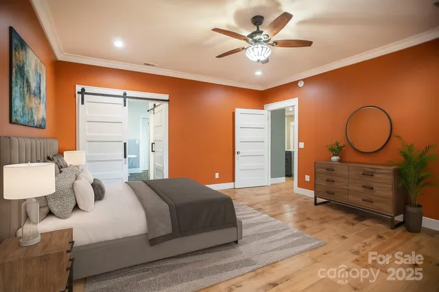 a bedroom with a bed and a chandelier