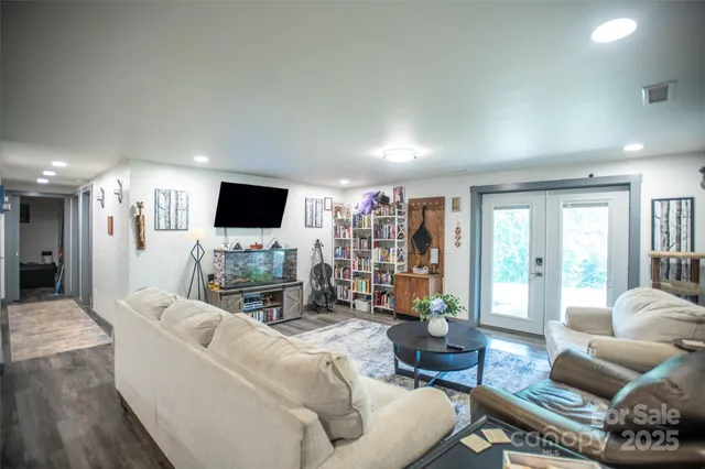 an aerial view of a residential houses with outdoor space and trees