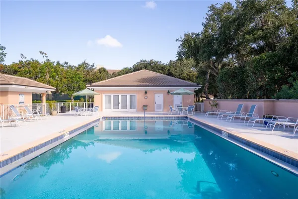 a view of a house with backyard and sitting area