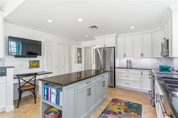 a kitchen with stainless steel appliances granite countertop a sink and a stove top oven
