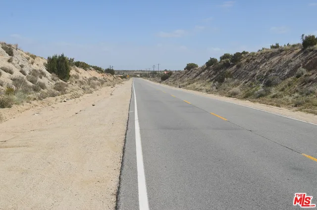 a view of a hall with a table and chairs