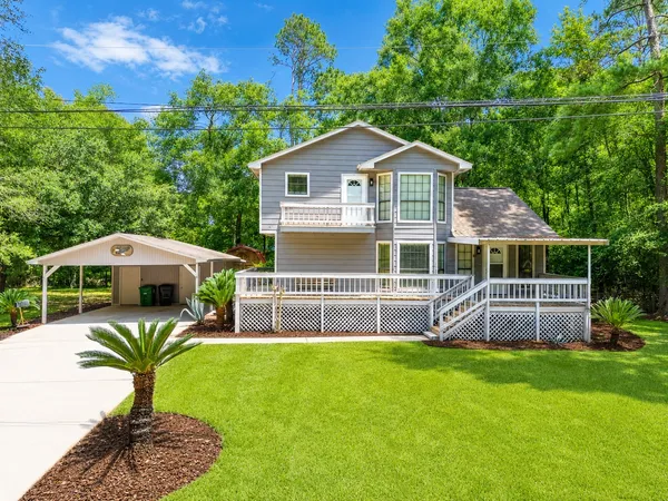 a front view of house with yard and outdoor seating