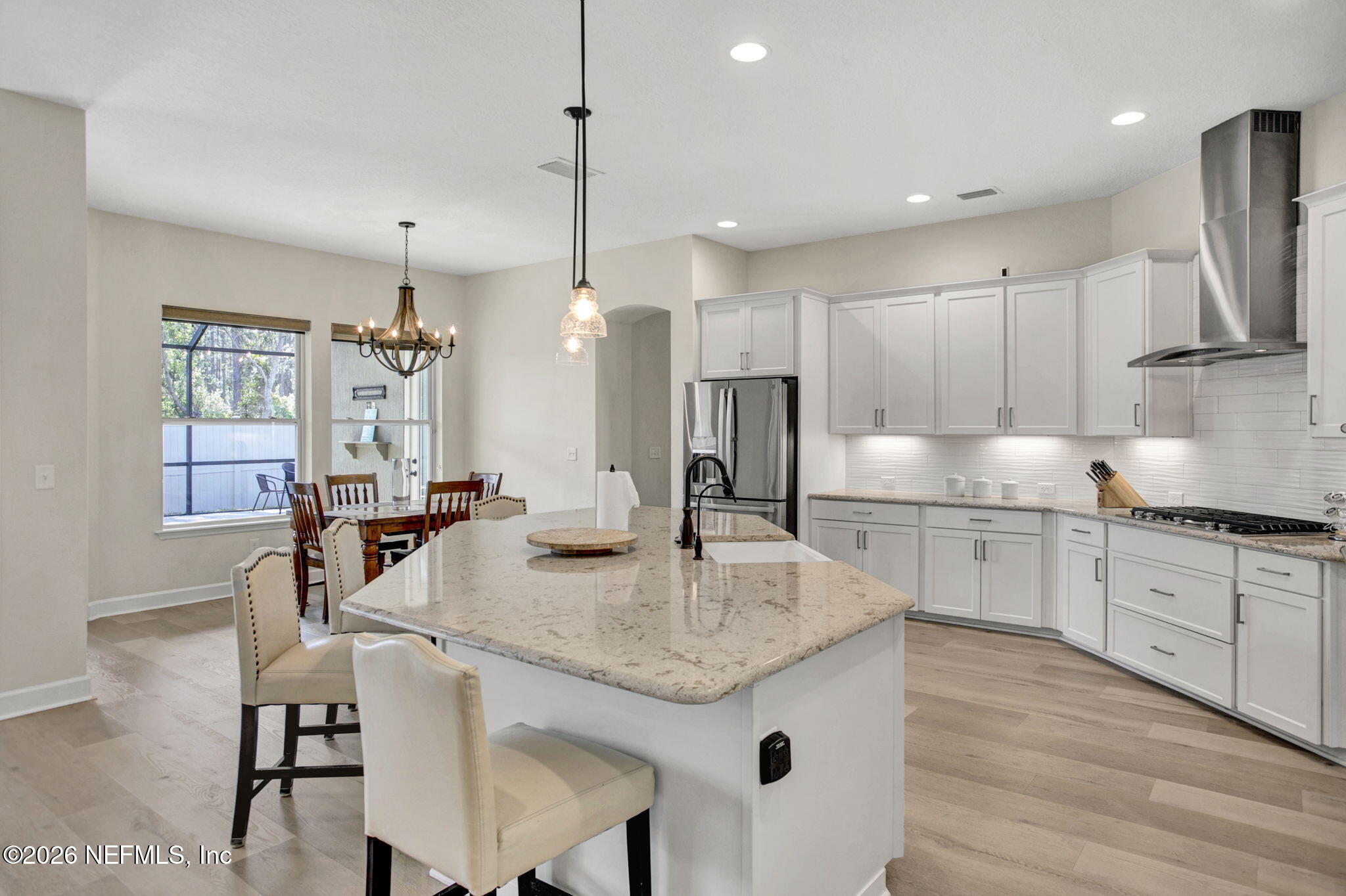 77 Manor Lane St. Johns, FL 32259 - Photo 12 of 41 a kitchen with granite countertop kitchen island a center island a sink stainless steel appliances and cabinets