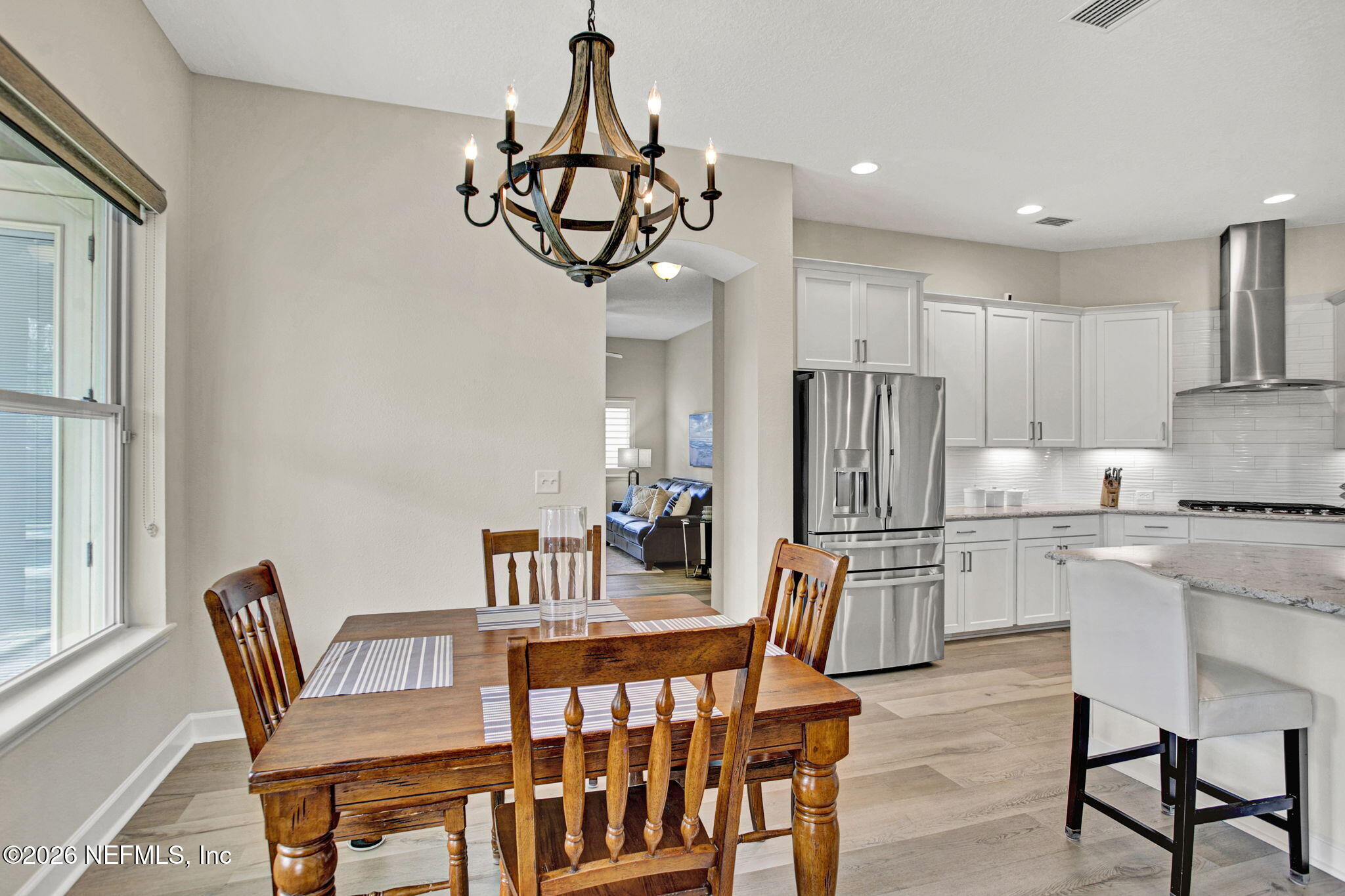 77 Manor Lane St. Johns, FL 32259 - Photo 15 of 41 a kitchen with a dining table chairs stainless steel appliances and cabinets