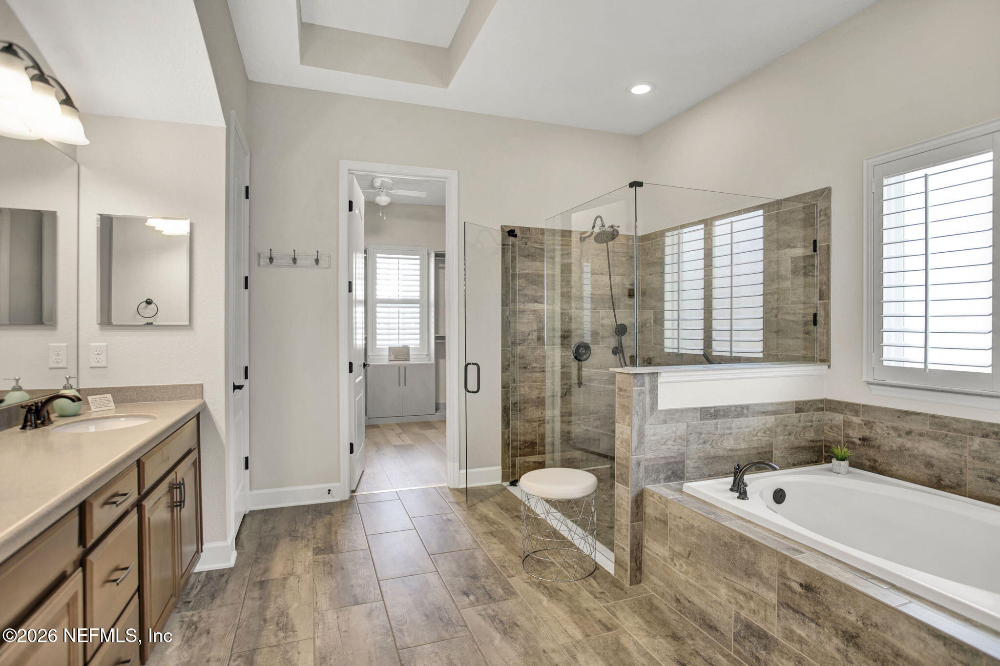 77 Manor Lane St. Johns, FL 32259 - Photo 18 of 41 a spacious bathroom with a tub sink shower and a mirror