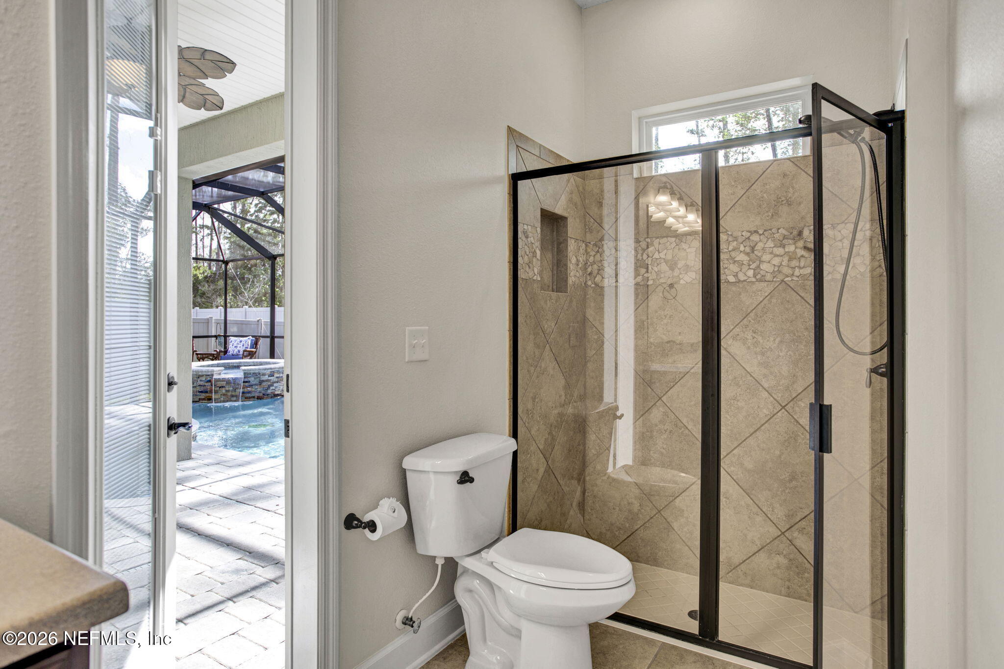 77 Manor Lane St. Johns, FL 32259 - Photo 26 of 41 a bathroom with a glass shower door