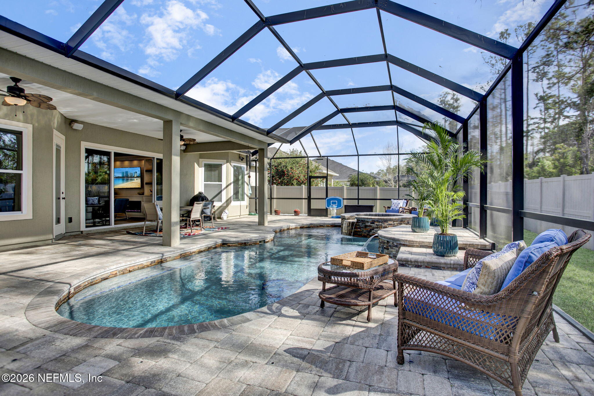 77 Manor Lane St. Johns, FL 32259 - Photo 33 of 41 a view of a patio with a table and chairs under an umbrella