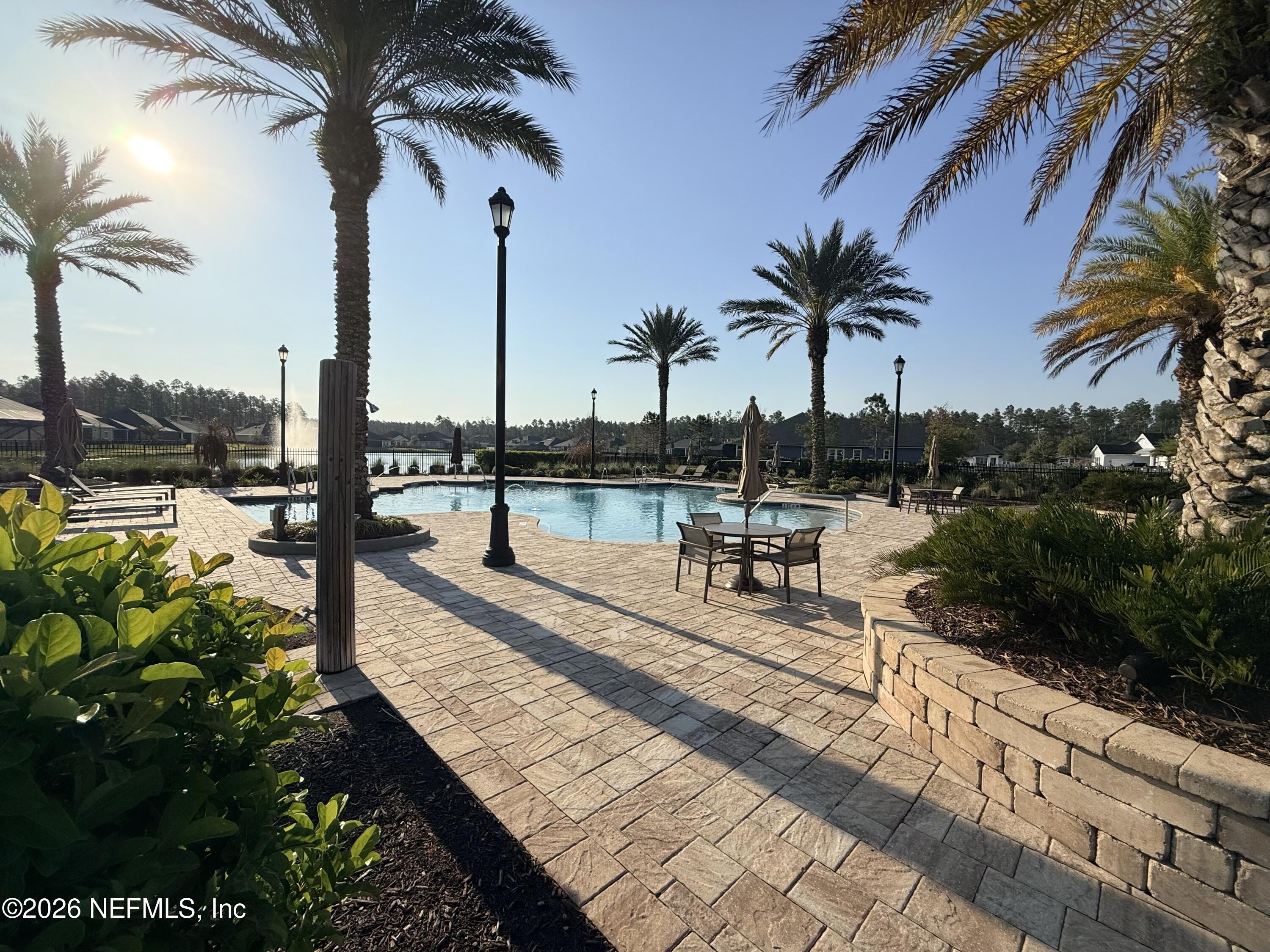 77 Manor Lane St. Johns, FL 32259 - Photo 38 of 41 a view of a swimming pool with a table and chairs