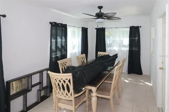 a dining room with furniture and window