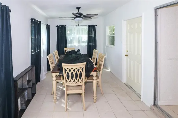 a dining room with furniture and window