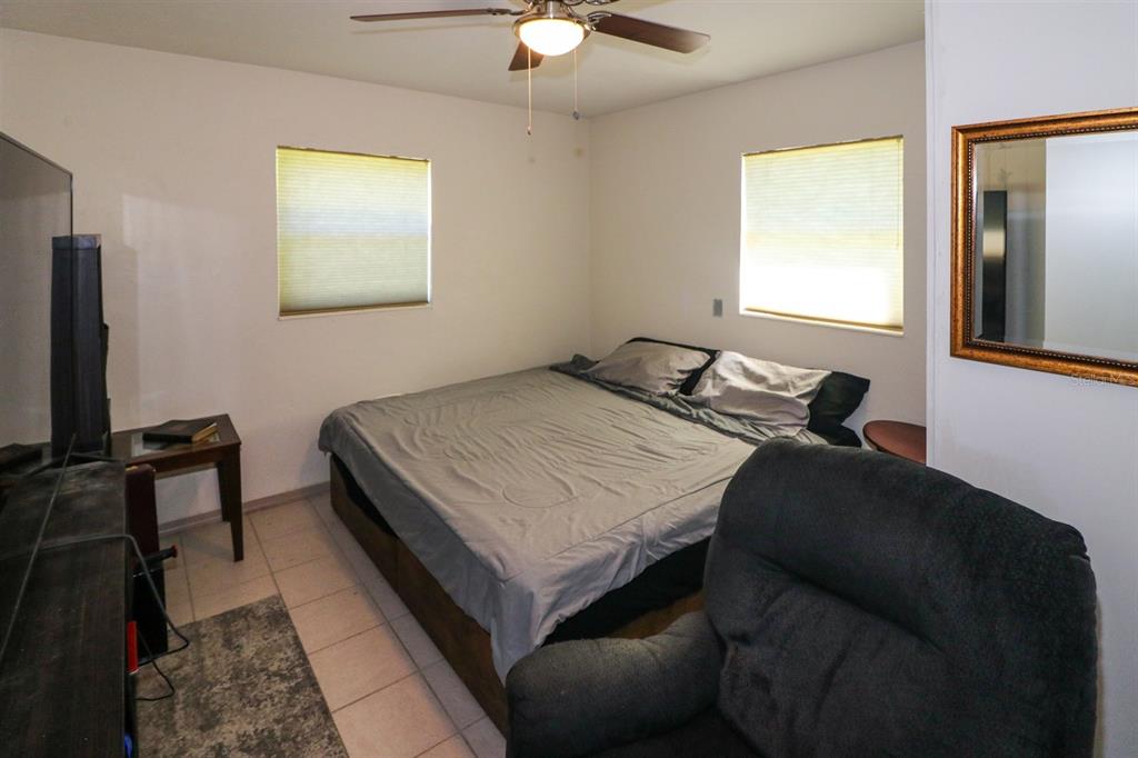 3580 Swanee Road Port Charlotte, FL 33980 - Photo 16 of 22 a bedroom with a bed and a chandelier