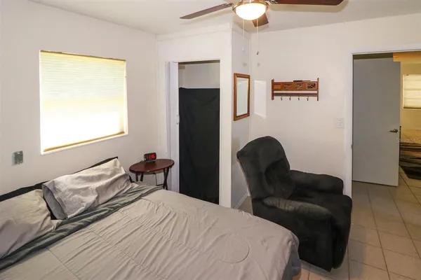 a bedroom with a bed and a chair