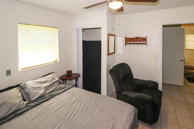 a bedroom with a bed and a chair