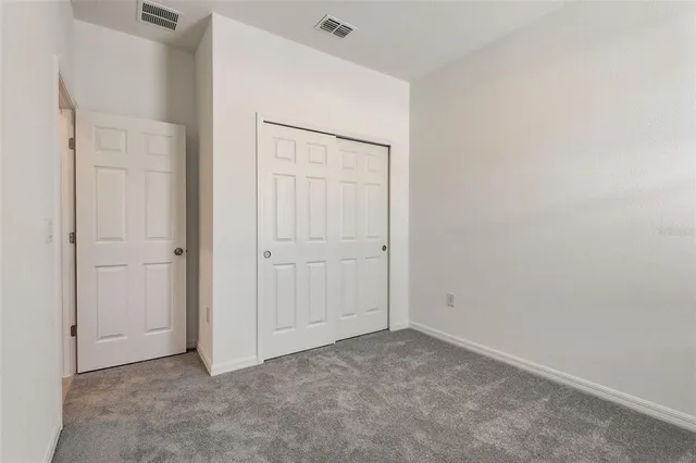an empty room with closet area