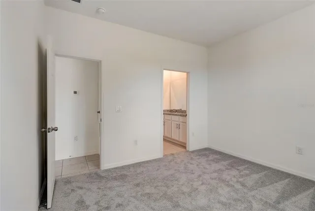 a bathroom with a granite countertop sink and a white white cabinets
