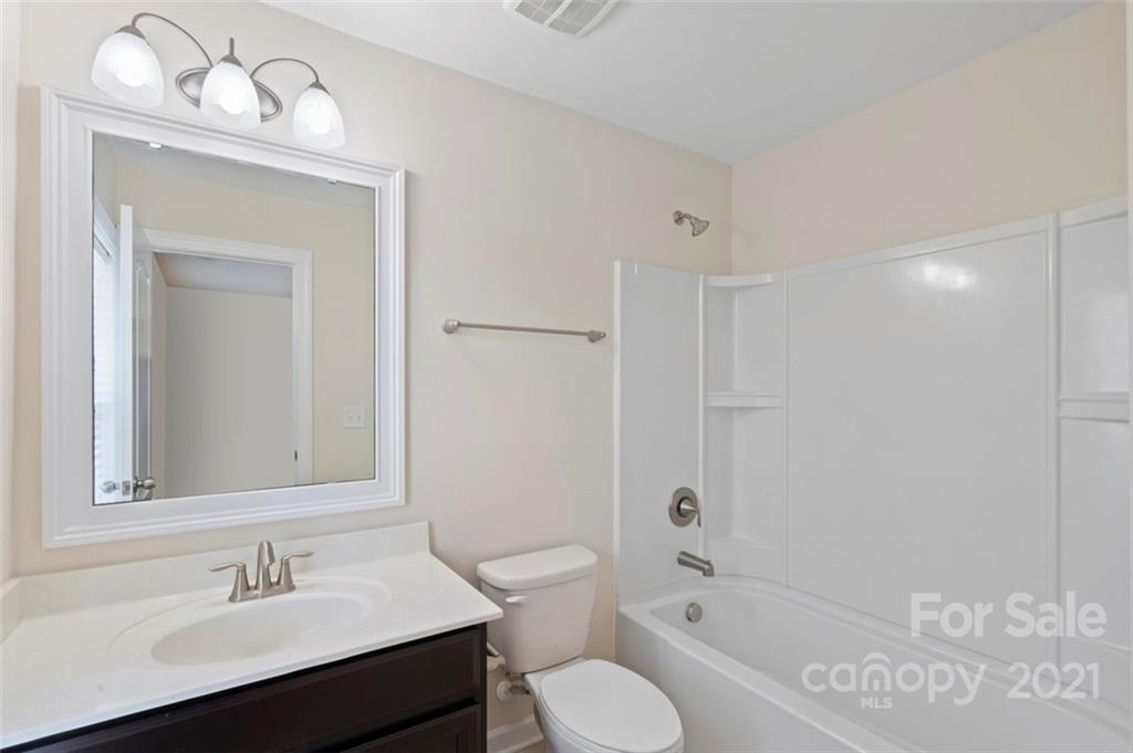 4331 Oxford Mill Road Waxhaw, NC 28173 - Photo 30 of 48 a bathroom with a sink a toilet a mirror and shower