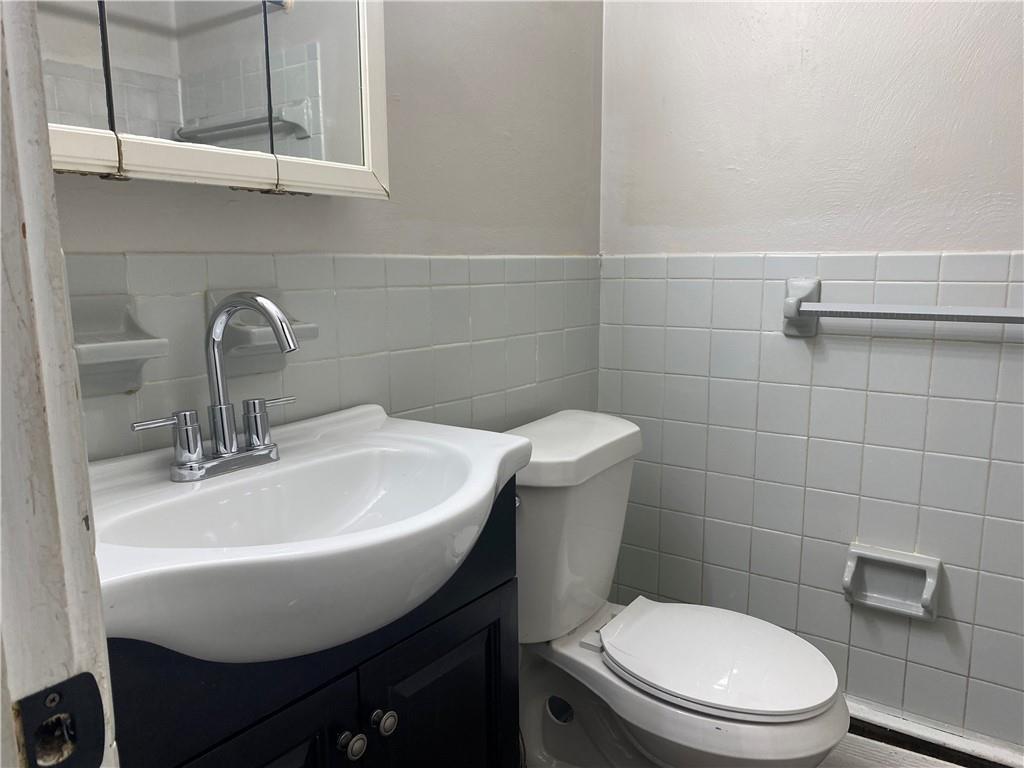 1 Penn Ridge Court, Unit 10 Pittsburgh, PA 15235 - Photo 15 of 23 a bathroom with a sink a toilet and a mirror