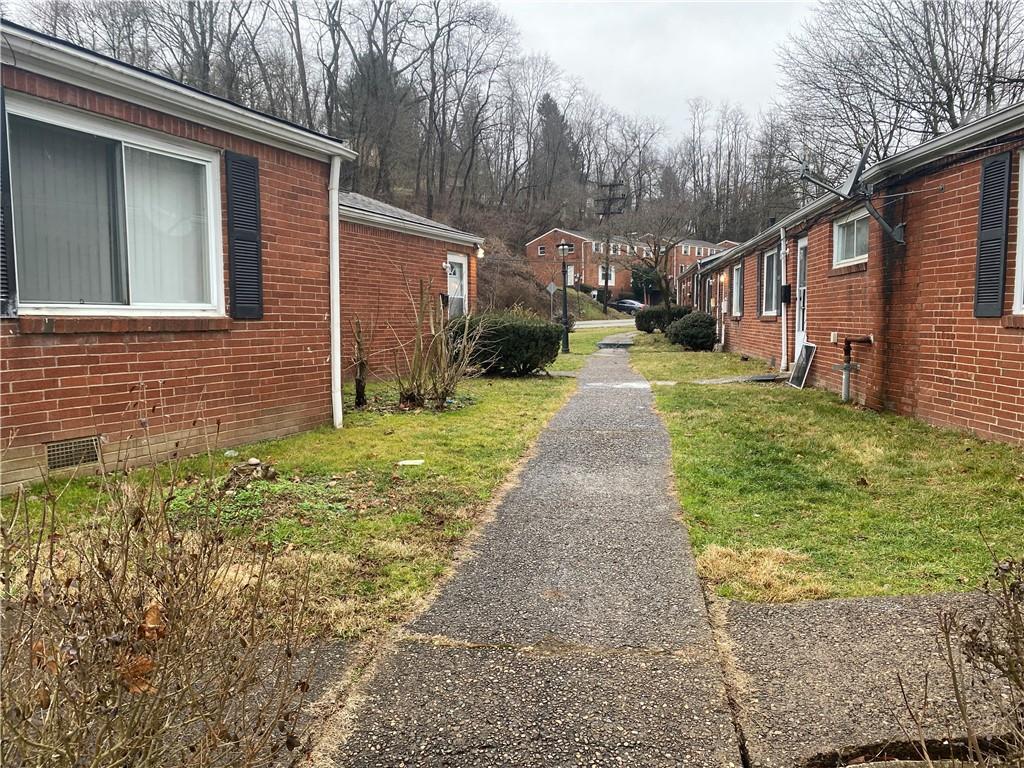 1 Penn Ridge Court, Unit 10 Pittsburgh, PA 15235 - Photo 20 of 23 a front view of a house with a yard and garage