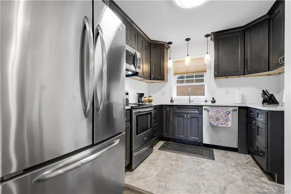 a kitchen with stainless steel appliances a refrigerator and a sink