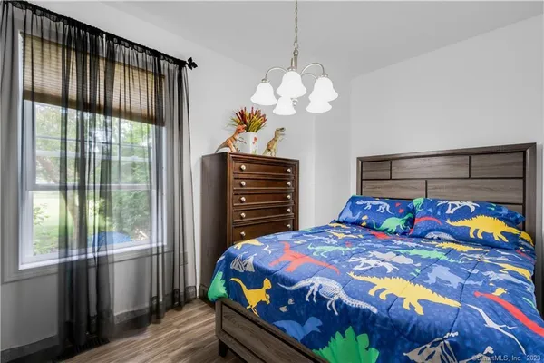 a bedroom with a bed and a chandelier