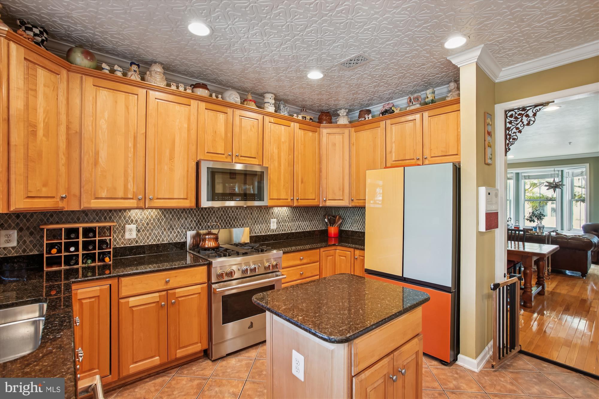 703 Capitol Square Place Southwest Washington, DC 20024 - Photo 11 of 66 a kitchen with stainless steel appliances granite countertop a refrigerator a stove a sink a microwave and dining table