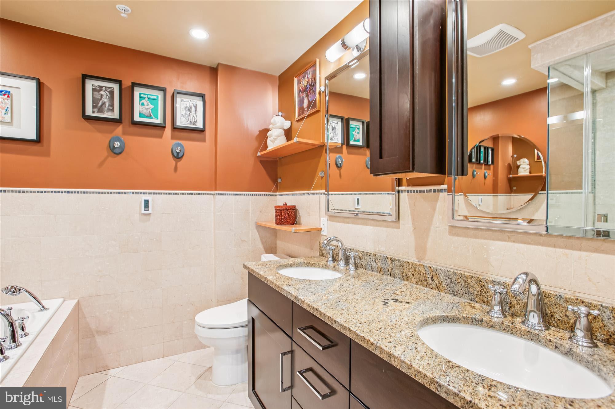 703 Capitol Square Place Southwest Washington, DC 20024 - Photo 34 of 66 a bathroom with a granite countertop sink a toilet and a mirror