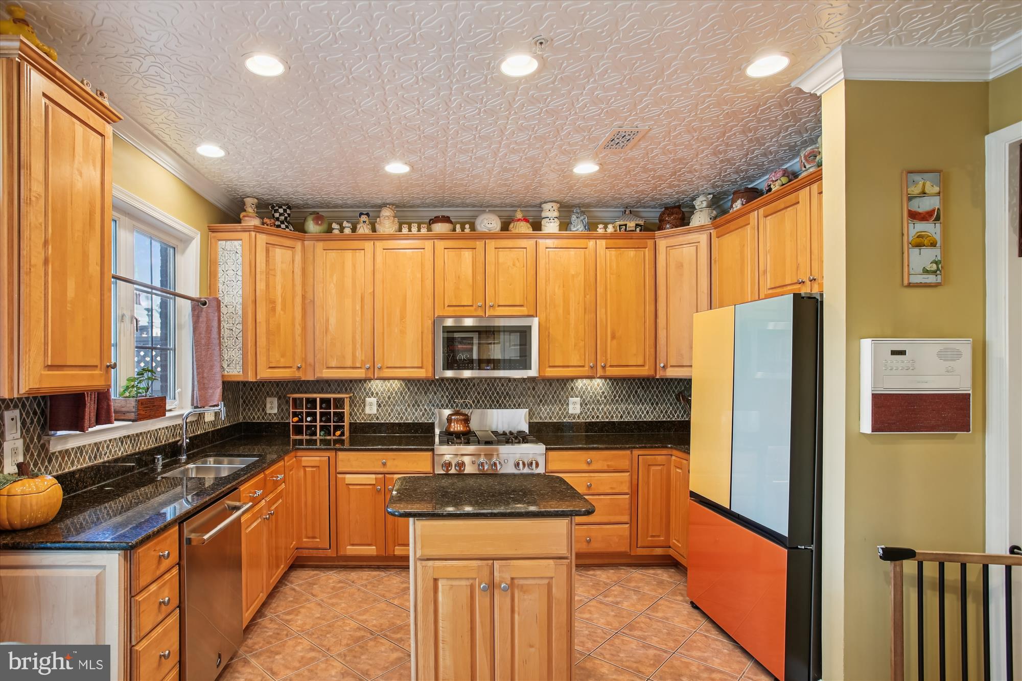 703 Capitol Square Place Southwest Washington, DC 20024 - Photo 10 of 66 a kitchen with stainless steel appliances granite countertop a refrigerator a sink dishwasher a stove and a dining table with wooden cabinet