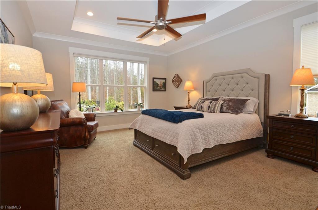 5578 Salem View Road Pfafftown, NC 27040 - Photo 21 of 48 Large main level primary bedroom has tray ceiling and gorgeous windows.