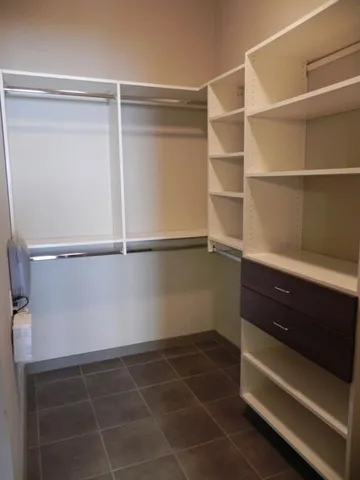 a room with a closet and wooden floor