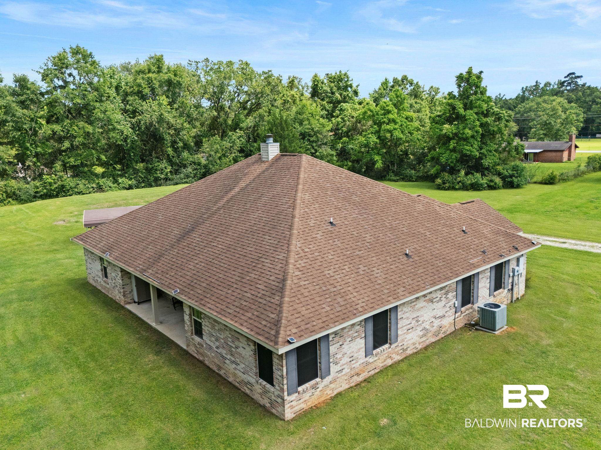 16151 Tolbert Road Bay Minette, AL 36507 - Photo 54 of 74 Single-story residence featuring a hip roof with brown shingles, brick exterior, and a covered patio