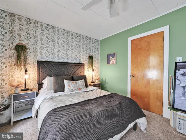 a bedroom with a bed and a television