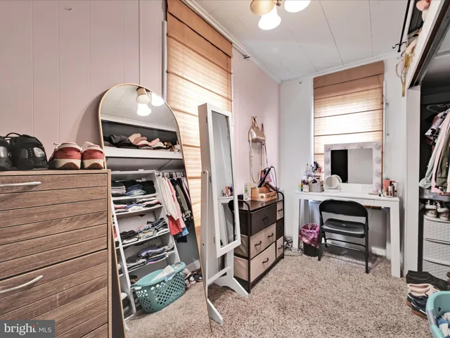 a bedroom with furniture and a flat screen tv