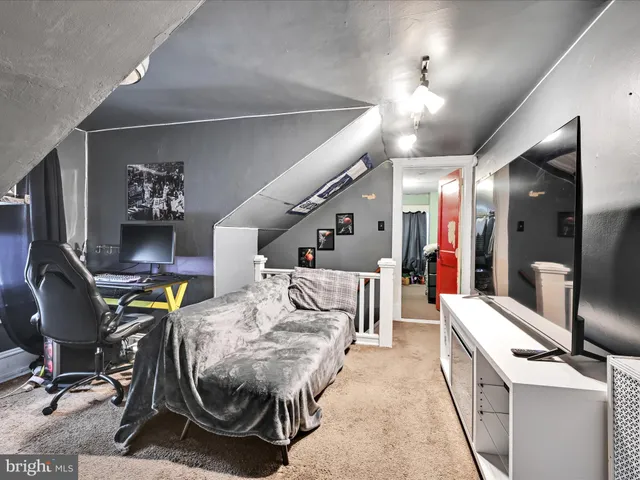 a living room with furniture and a gym machine