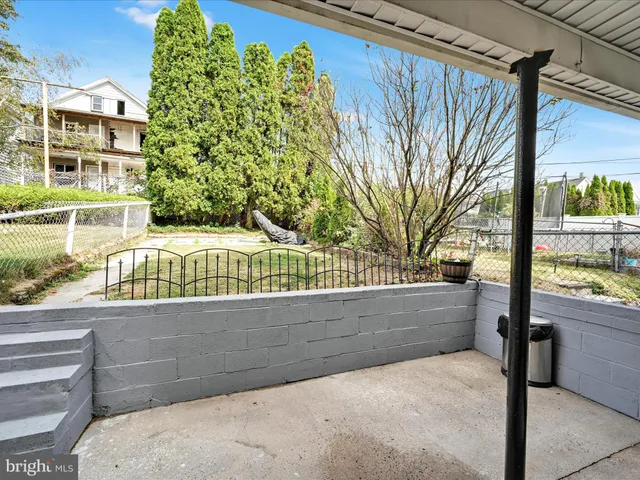 a building outdoor space with patio furniture and potted plants