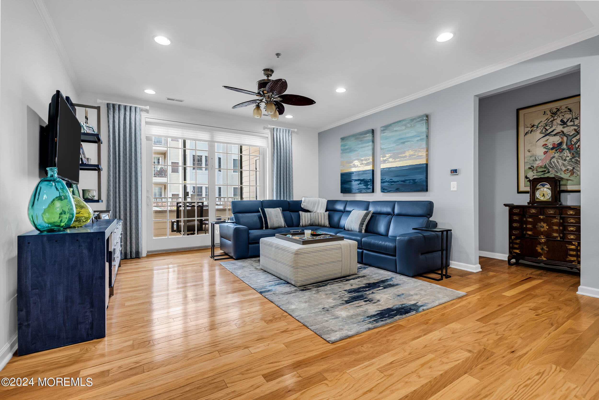 33 Cooper Avenue, Unit 215 Long Branch, NJ 07740 - Photo 11 of 27 a living room with furniture a window and a flat screen tv