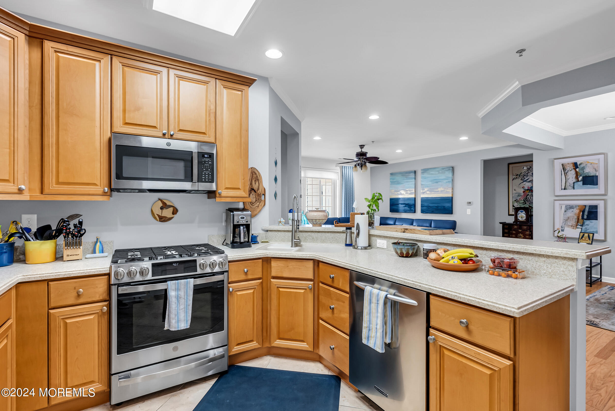 33 Cooper Avenue, Unit 215 Long Branch, NJ 07740 - Photo 14 of 27 a kitchen with a stove a sink and a microwave