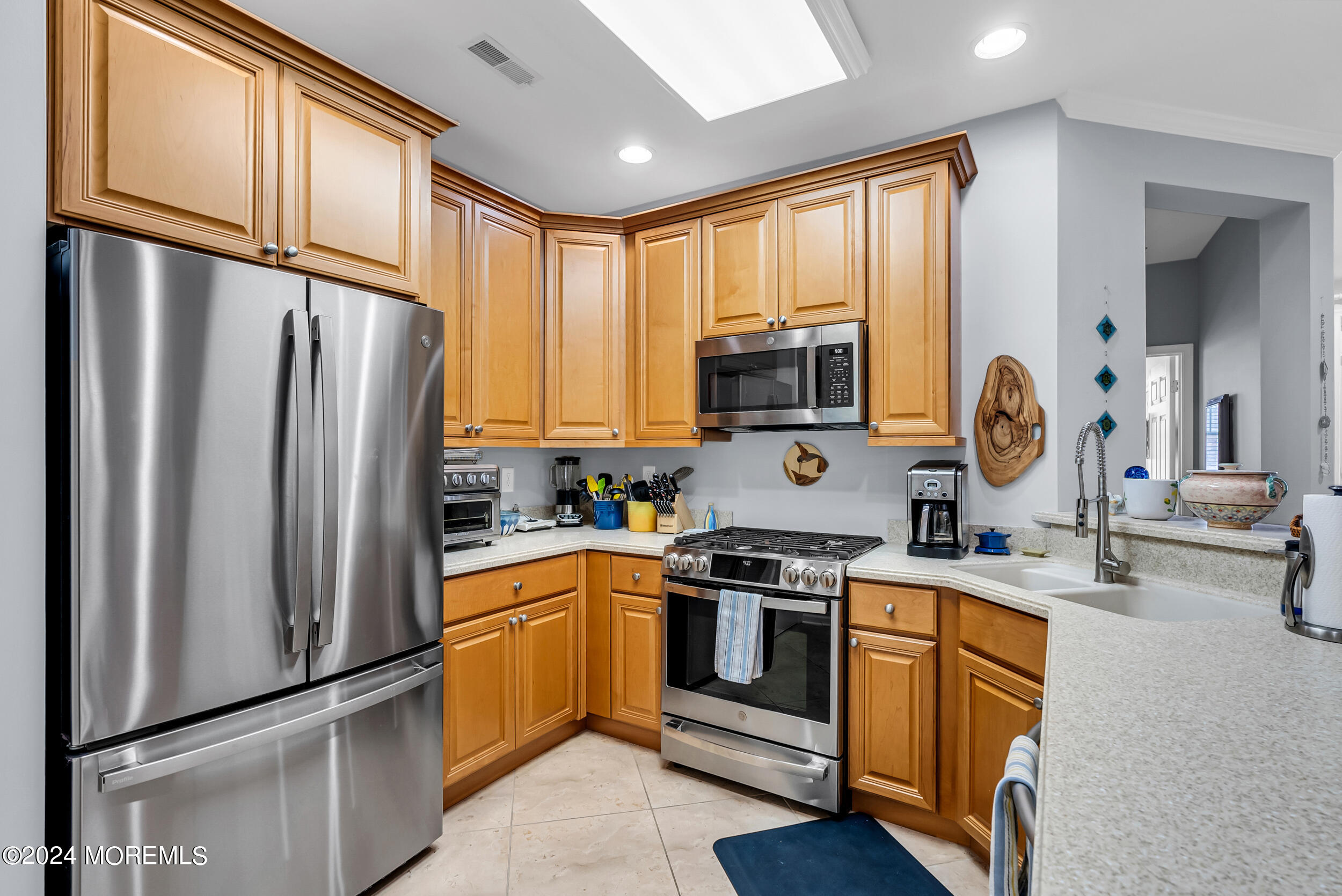 33 Cooper Avenue, Unit 215 Long Branch, NJ 07740 - Photo 15 of 27 a kitchen with stainless steel appliances granite countertop a refrigerator stove and sink