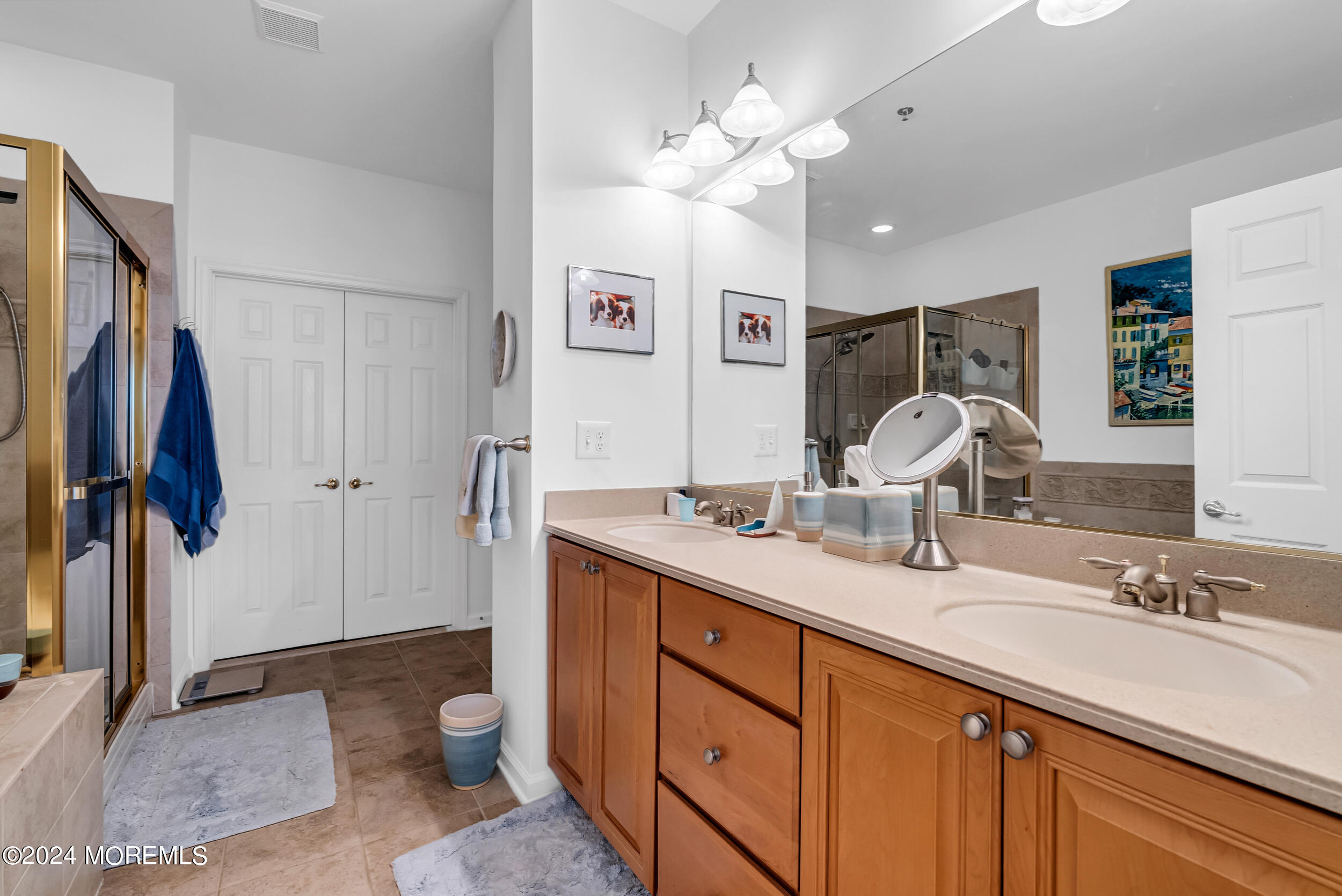 33 Cooper Avenue, Unit 215 Long Branch, NJ 07740 - Photo 21 of 27 a spacious bathroom with a double vanity sink mirror and toilet