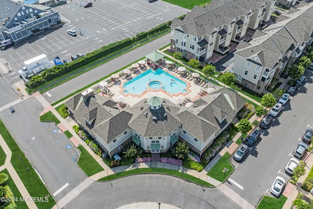 an aerial view of a pool patio chairs and fire pit